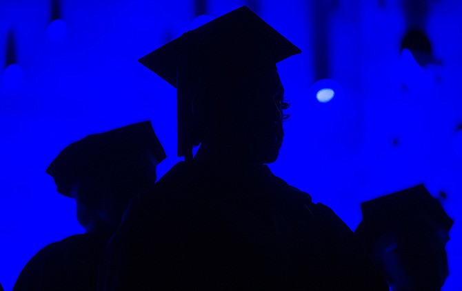 In this Saturday, May 31, 2014 photo, members of the graduating class and faculty attend the SCAD Commencement in Atlanta.