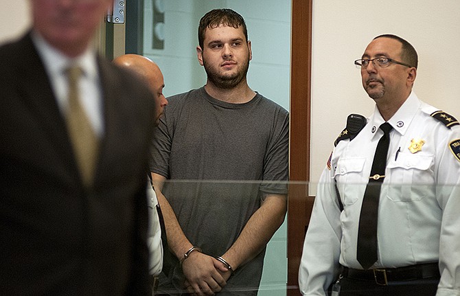 Gregory Lewis stands in the holding cell door, escorted by court officers, as his dangerousness hearing ends in Worcester Superior Court in Worcester, Mass. Monday, Nov. 10, 2014. Authorities said Lewis cut off his court-ordered electronic monitoring device and fled Massachusetts after being charged in the rape of a 13-year-old girl. He is suspected of robbing and raping female escorts in Colorado, Indiana, Missouri, Oregon, North Carolina and Utah.