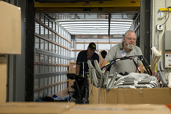  Larry Boothe and other members of Allied Hospital Services move a box full of crutches and other medical equipment into the new St. Mary's Hospital Thursday afternoon in preparation for the big move Sunday to the new location at the intersection of Mission Drive and Missouri 179. 