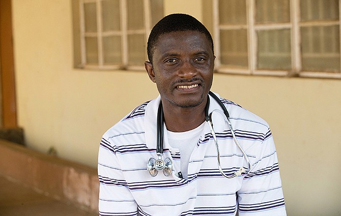 In this April 2014 photo provided by the United Methodist News Service, Dr. Martin Salia poses for a photo at the United Methodist Church's Kissy Hospital outside Freetown, Sierra Leone. Salia has tested positive for Ebola and will be flown, on Saturday, Nov. 15, 2014, to the Nebraska Medical Center, in Omaha, Neb., for treatment. (AP Photo/United Methodist News Service, Mike DuBose)