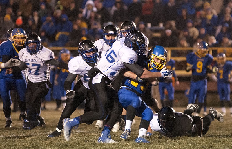 South Callaway senior linebacker Dylan Hare takes down East Buchanan senior running back Ryan Kilgore during third-ranked South Callaway's 21-8 victory over fourth-ranked East Buchanan in Friday night's Class 2 quarterfinal matchup in Gower. South Callaway (13-0) travels to Palmyra (9-4) next Friday night for a semifinal clash. 