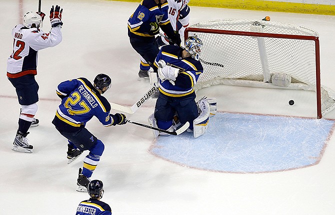 Washington Capitals' Joel Ward, left, celebrates after scoring past St. Louis Blues goalie Brian Elliott, right, and Alex Pietrangelo (27) during the second period of an NHL hockey game Saturday, Nov. 15, 2014, in St. Louis. 