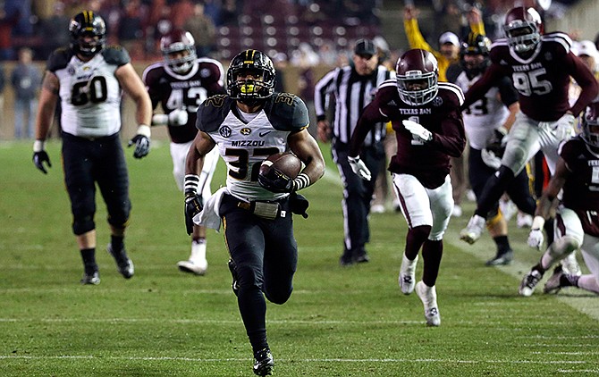 Missouri running back Russell Hansbrough (32) rushes 45 yards for a touchdown against Texas A&M during the second half of an NCAA college football game Saturday, Nov. 15, 2014, in College Station, Texas.