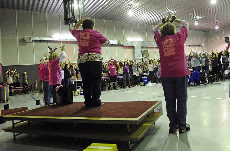 Ellis Fischel Cancer Center breast clinic nurses lead the crowd in a simultaneous self breast examination during Saturday night's Doe's Night Out fundraiser at the Loose Creek Community Center. 
The event was originally conceived by breast cancer survivor Jenny Samson Morgan as a way to raise awareness about the importance of self breast examinations while also raising funds for the Community Breast Care Project of Central Missouri.