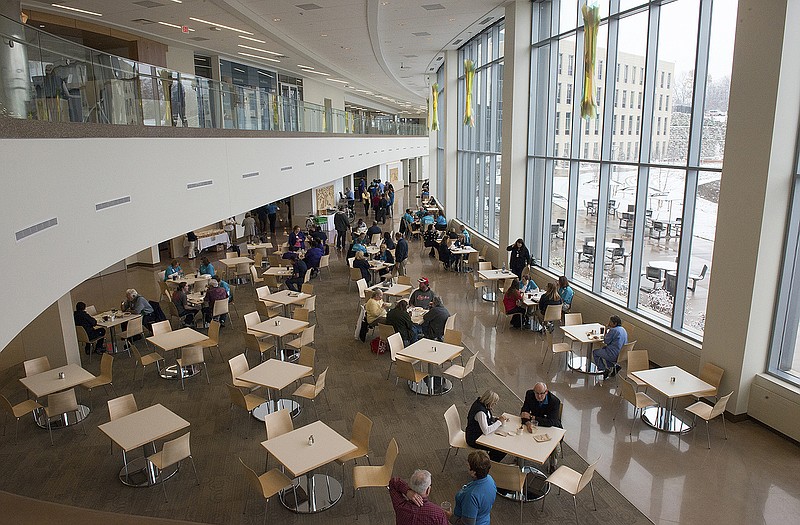 People sit at tables in the cafeteria of the new St. Mary's Hospital. 
