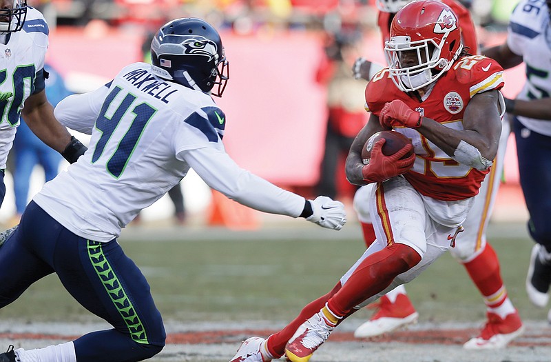 Chiefs running back Jamaal Charles runs from Seahawks cornerback Byron Maxwell in the second half of Sunday's game in Kansas City.