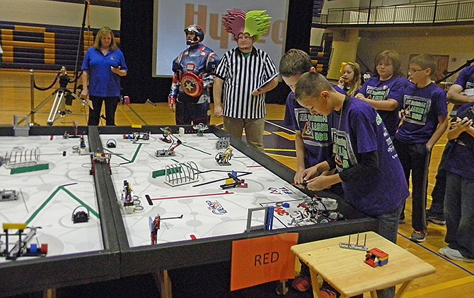 One of the Camdenton teams works on their robot while waiting for the "Let's Lego" signal, which starts the competition.