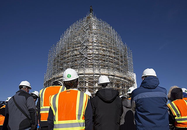 Members of the media gather for a news conference on the roof of the Capitol Building in Washington, Tuesday to announce the completion of the scaffolding and the start of the repairs for the Capitol Dome Restoration Project.