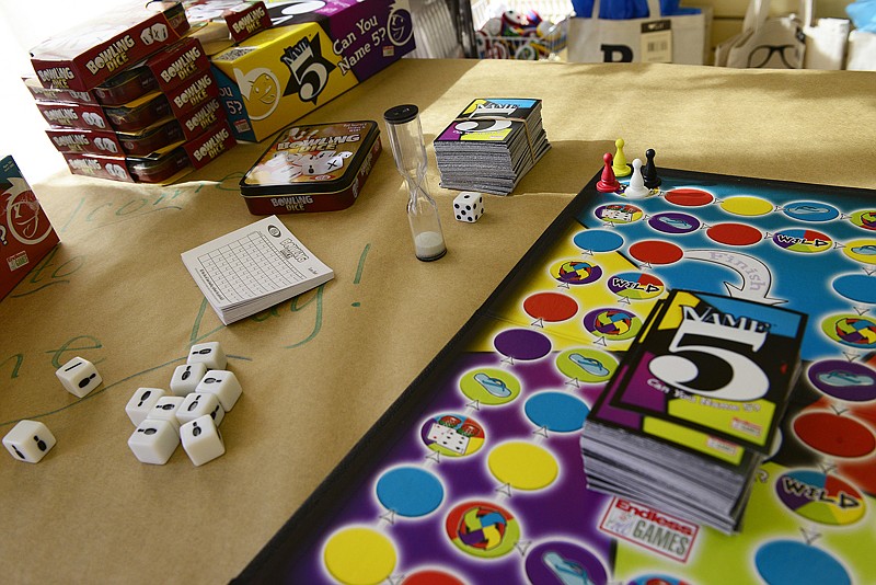 Downtown Book & Toy on East High Street offered Jefferson City residents and visitors a chance to try out some board games like Name 5, pictured here, during Downtown Jefferson City's Holiday Open House Saturday, Nov. 8, 2014.