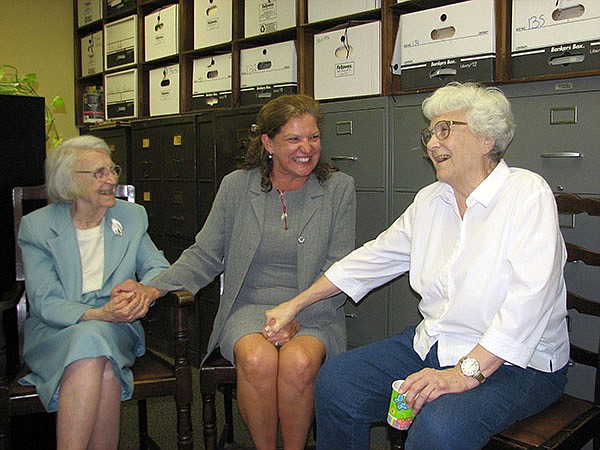 In this 2006 photo, attorney Alice Lee, left, accepts birthday wishes from Monroe County Circuit Judge-elect Dawn Hare, center, and her sister, Pulitzer-winning author Harper Lee, right, in Monroeville, Alabama. Alice Lee died Monday, she was 103.