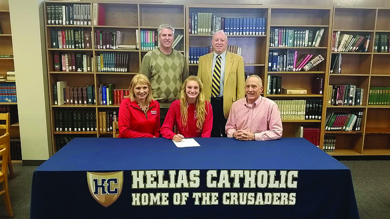 Erica Haslag (seated, center) signed a letter of intent Monday to play volleyball at Bradley University. Seated with Haslag are her parents, Patricia and Jim Haslag. Standing are club ball coach Paul Dupuis (left) and Helias head coach David Harris.