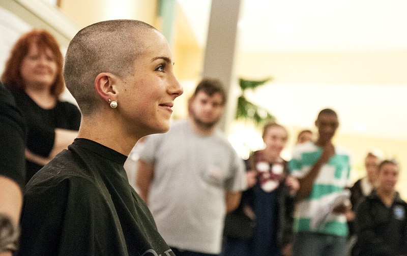 Westminster College student Brier Skogsberg smiles after having her head shaved for the Pantene Beautiful Lengths program Wednesday inside the Coulter Science Center during the school's Brave A Shave event.