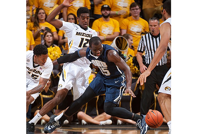 Oral Roberts' Obi Emegano, right, loses control of the ball as Missouri's Wes Clark, left, and Namon Wright defend during the first half of an NCAA college basketball game Wednesday, Nov. 19, 2014, in Columbia, Mo.