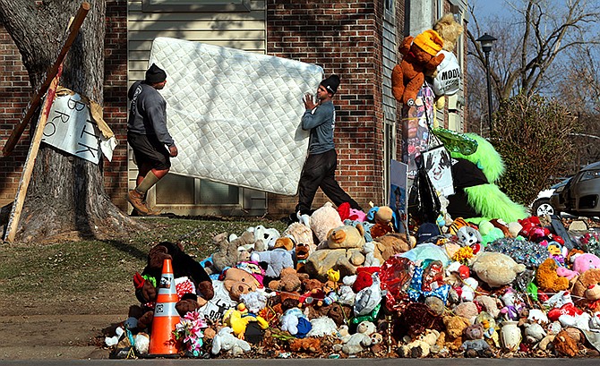 A resident of the Canfield Green apartments in Ferguson, Mo., who lived right above the spot where Michael Brown was killed, moves out on Wednesday, Nov. 19, 2014, in advance of a St. Louis county grand jury decision. The woman and her niece both declined to be interviewed, but the niece answered a question about whether her aunt was moving because of the upcoming news. "You bet your butt she is," she said.