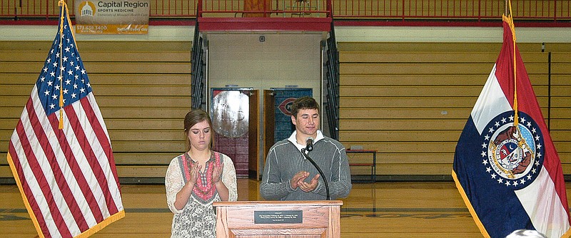 At the California High School and Middle School Veterans Day Assembly, Rylee Glenn, left, and Matt Oerly, lead the students and staff present in applause for veterans present at the assembly and veterans in general.