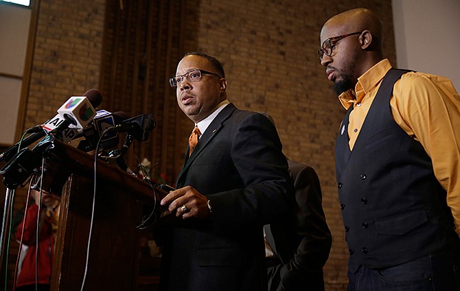 Anthony Gray, attorney for the family of Michael Brown, speaks as National Action Network Ferguson chapter president Rev. Carlton Lee, right, listens during a news conference Friday, Nov. 21, 2014, in St. Louis County, Mo. Gray and Lee spoke about preparations as citizens wait for a decision from the grand jury whether to indict Ferguson police officer Darren Wilson in the shooting of Michael Brown.