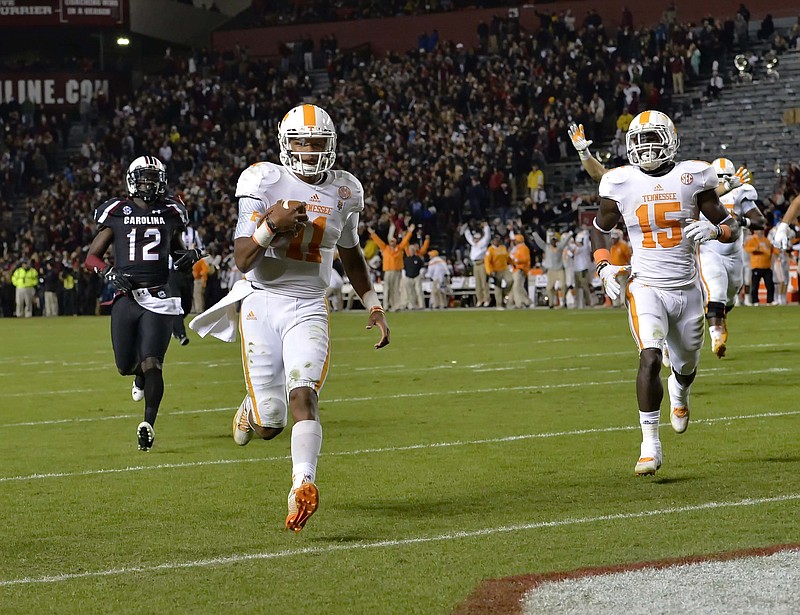 Tennesse quarterback Joshua Dobbs, shown cruising into the end zone for a touchdown during a game against South Carolina on Nov. 1 in Columbia, S.C., will pose some problems for Missouri's defense today.