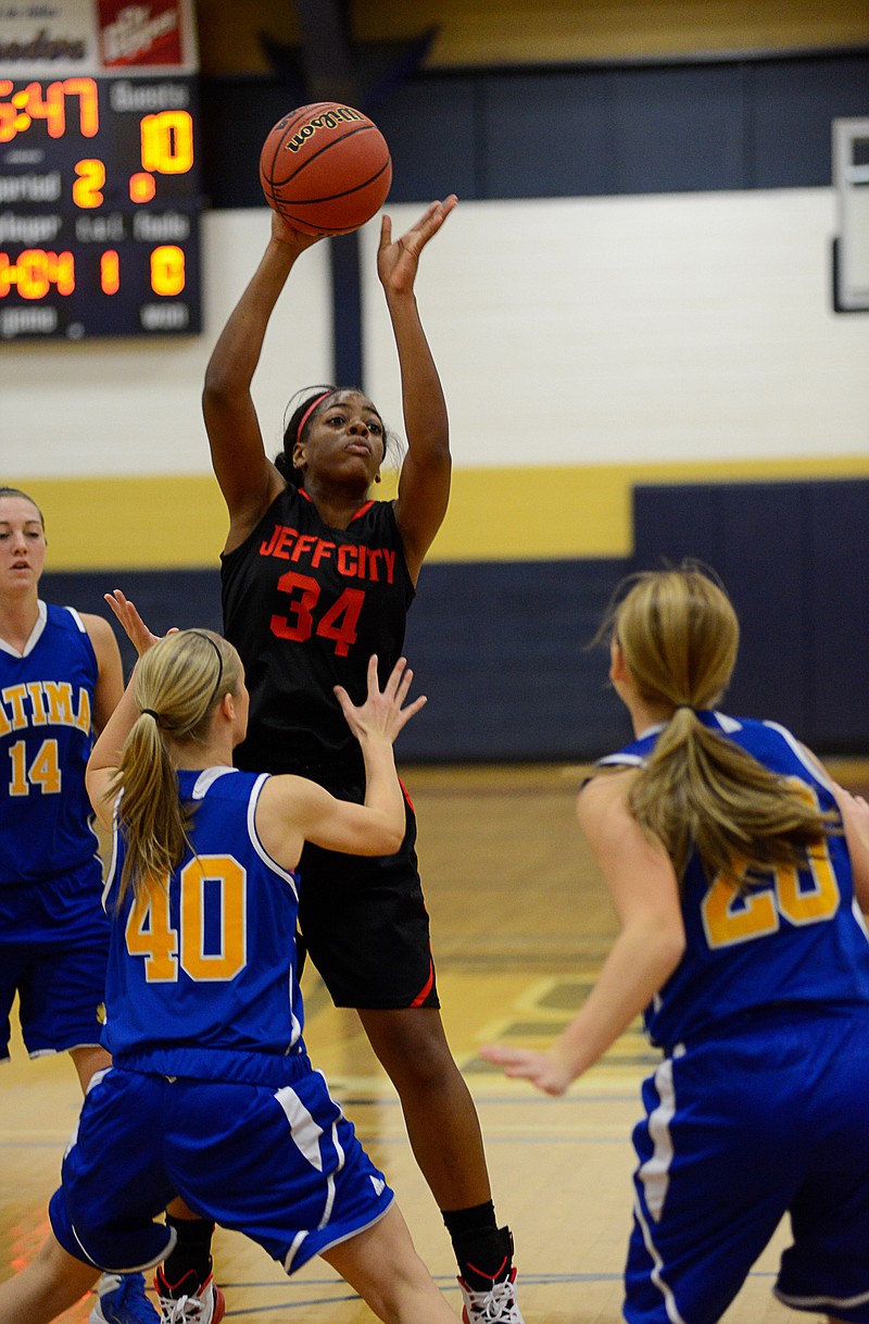 Jefferson City's Nicole Martin draws the attention of several Fatima defenders in Friday's game at the Helias Gym.