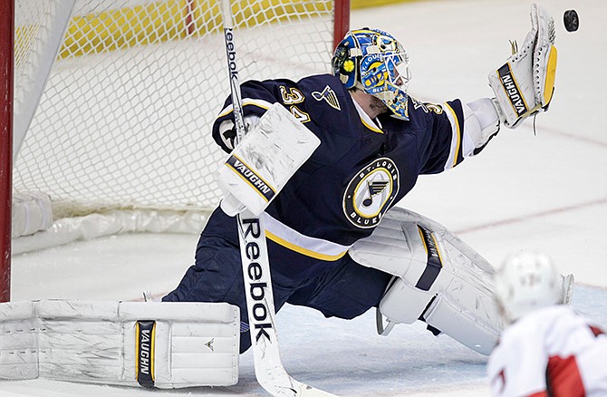 St. Louis Blues goalie Jake Allen (34) makes a glove save in the overtime period of a NHL hockey game against the Ottawa Senators, Tuesday, Nov. 25, 2014 in St. Louis. The Senators beat the Blues 3-2 in a shootout,