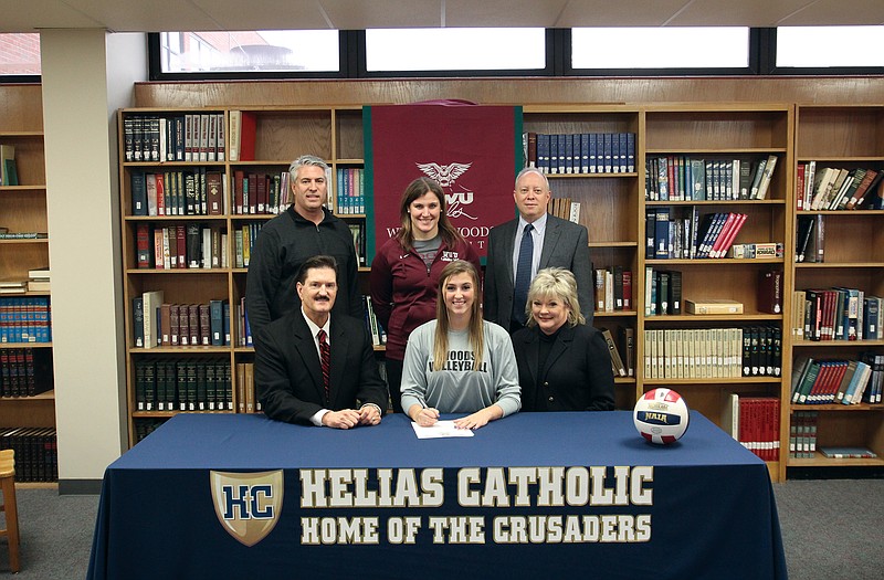 Tory Wiley (seated, center), a senior member of the undefeated state champion team at Helias High School, signs a letter of intent to play volleyball at William Woods. Also seated are her parents, Bruce and Nancy Wiley. Standing (from left) are club coach Paul Dupuis, William Woods coach Monica Herschelman and Helias head coach David Harris.