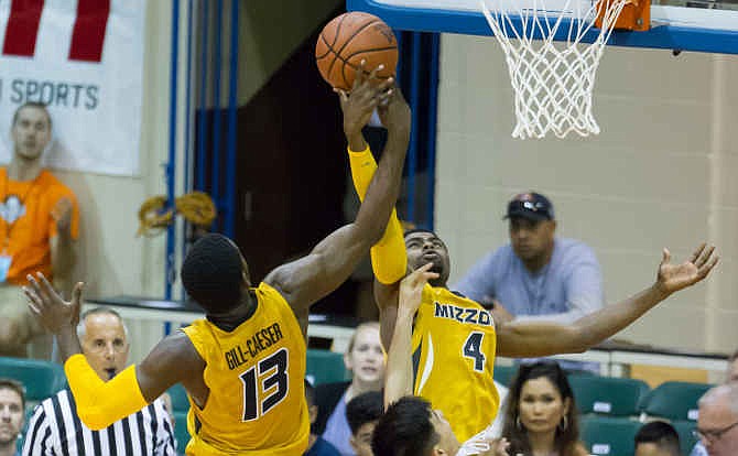 Missouri guards Montaque Gill-Caesar (13) and Tramaine Isabell (4) work to control a rebound while playing against Chaminade in the second half of an NCAA college basketball game at the Maui Invitational on Wednesday, Nov. 26, 2014, in Lahaina, Hawaii. Missouri won 74-60.