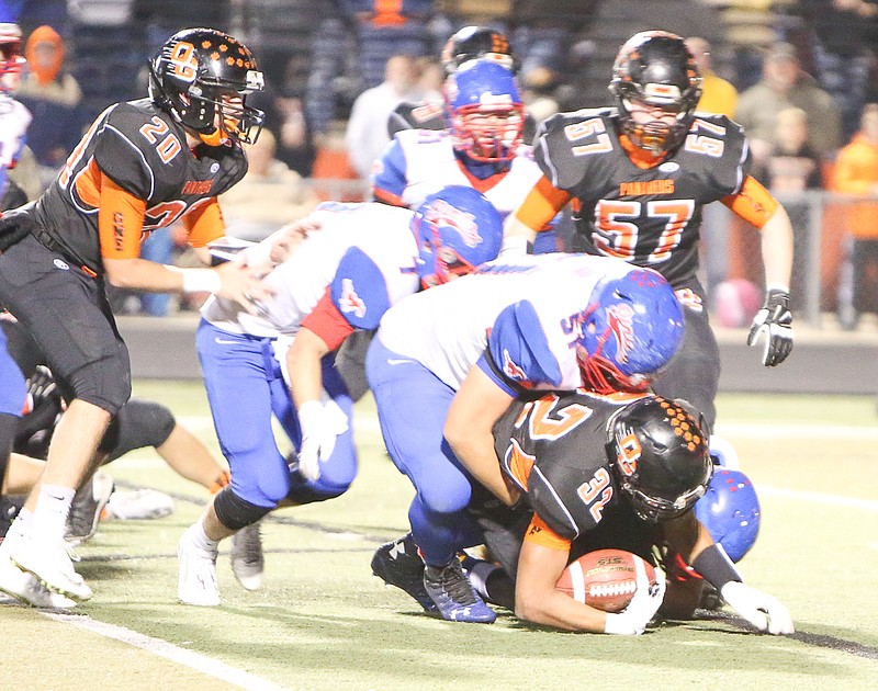 Pintos senior Nathan Squires (51) tackles Oak Grove running back Aaron Graham in Friday night's Class 3 state semifinal at Oak Grove. The host Panthers, led by Graham, beat California 49-14.