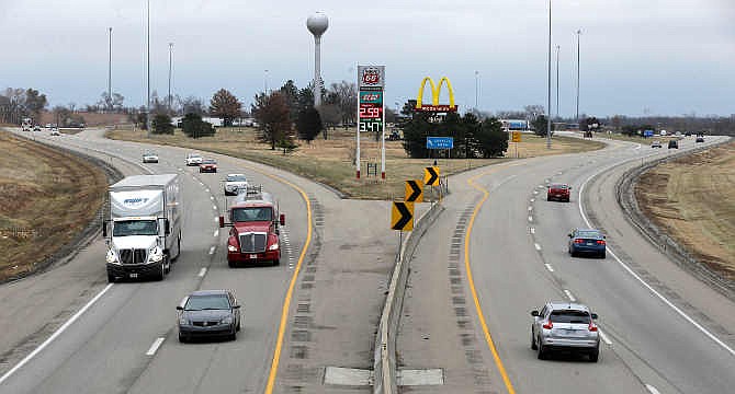 Motorists drive along the Interstate 70 portion of the Kansas Turnpike, past a rest area near Linwood, Kan., Wednesday, Nov. 26, 2014. Travelers are giving thanks for some of the cheapest fuel prices in years.