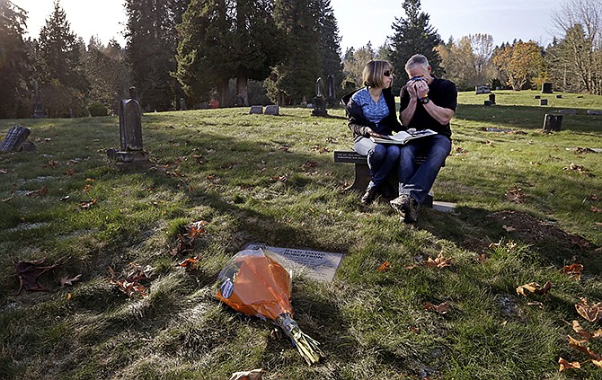 Rob Robertson wipes away tears as he sits with his wife Linda while they visit the grave of their son, Ryan, in Issaquah, Washington. The couple, evangelical Christians, brought their son to "reparative therapy" when he came out to them as gay. His sexual orientation didn't change, and he became addicted to drugs and eventually died of an overdose. The Robertsons are now dedicated to helping other evangelical parents accept their gay children. 