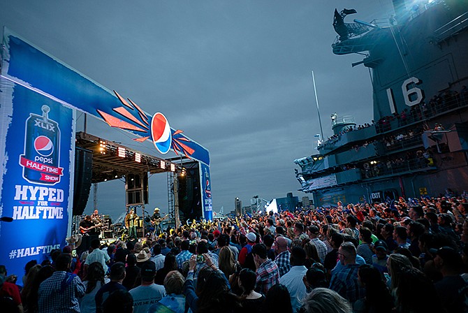 Blake Shelton appears on stage during the taping of a Super Bowl commercial on an aircraft carrier near Corpus Christie, Texas. Pepsi has been a long time Super Bowl sponsor and is sponsoring the halftime show, which stars Katy Perry, for the third time this year. 