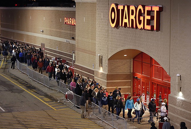 Shoppers head into Target just after the doors opened at midnight on Black Friday in South Portland, Maine. 