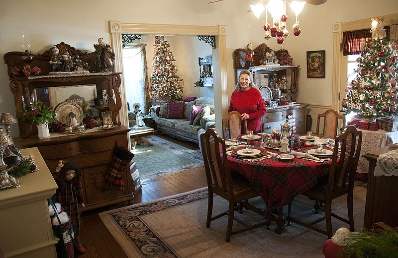 Judi Plummer of Portland smiles for a photo inside her dining room Friday. Plummer and her husband, Bob, will host a Christmas home tour 2-7 p.m. Dec. 7 and 2-5 p.m. Dec. 20. The tour is free and donations will go to the Portland Community Center.