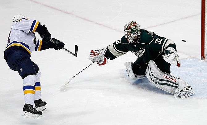 The game-winning shot by St. Louis Blues right wing Vladimir Tarasenko, left, of Russia, gets past Minnesota Wild goalie Niklas Backstrom (32), of Finland, during a shootout in an NHL hockey game in St. Paul, Minn., Saturday, Nov. 29, 2014. The Blues won 3-2 in a shootout. 