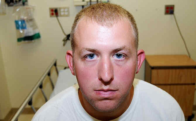 This undated file photo released by the St. Louis County Prosecuting Attorney's office on Monday, Nov. 24, 2014, shows Ferguson police officer Darren Wilson during his medical examination after he fatally shot Michael Brown, in Ferguson, Mo. The white police officer who killed Michael Brown has resigned from the Ferguson Police Department, nearly four months after the confrontation that fueled protests in the St. Louis suburb and across the U.S. Wilson has been on administrative leave since the Aug. 9 shooting. His resignation was announced Saturday, Nov. 29, 2014, by one of his attorneys, Neil Bruntrager. Bruntrager said the resignation is effective immediately. (AP Photo/St. Louis County Prosecuting Attorney's Office, File)