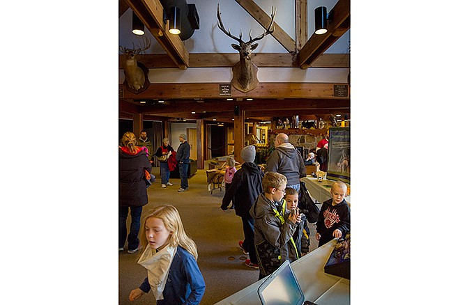 Visitors of all ages browse a series of elk-related exhibits Friday morning at Runge Nature Center in Jefferson City during the "Shopping Alternatives: They're back - ELK!" event. Since their reintroduction into Missouri a few years ago, the state's free-roaming elk population continues to increase with each new generation of Missouri elk.