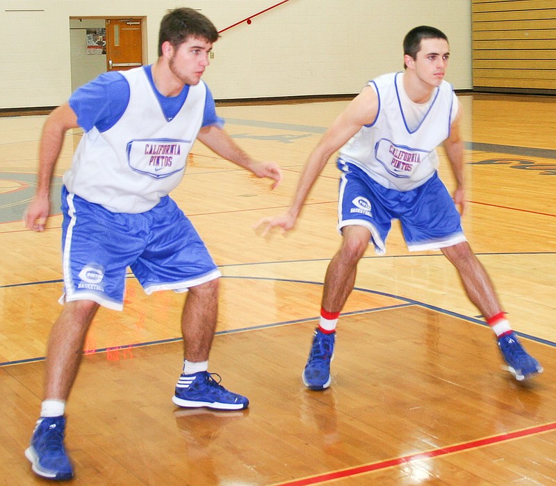California seniors Jaden Barr (left) and Drew Norton take part in a defensive drill at practice on Friday, Nov. 28. Barr and Norton each play football and basketball for the Pintos.
