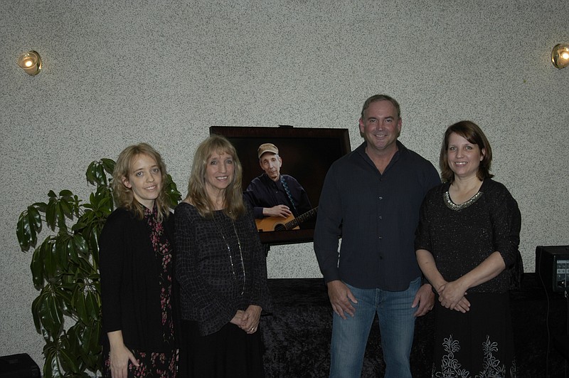The immediate family of Randall Effner in front of his photo are, from right, daughter Sara Effner, wife Dianna Effner, son Ivan Hobbs, and daughter Lela Street. Randall and Dianna have 12 grandchildren.