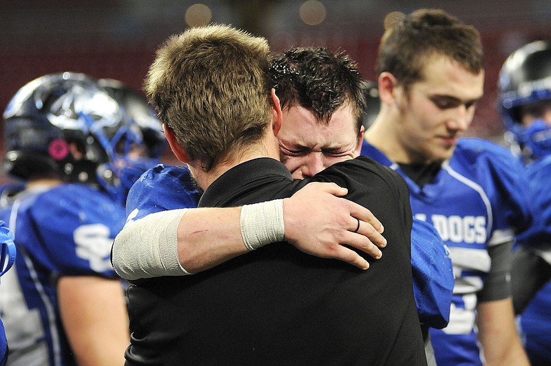 South Callaway senior slot receiver Cory Hanger and head coach Tim Rulo share a postgame embrace after the Bulldogs' 30-15 loss to Lamar on Saturday, Nov. 29 at the Edward Jones Dome in St. Louis.