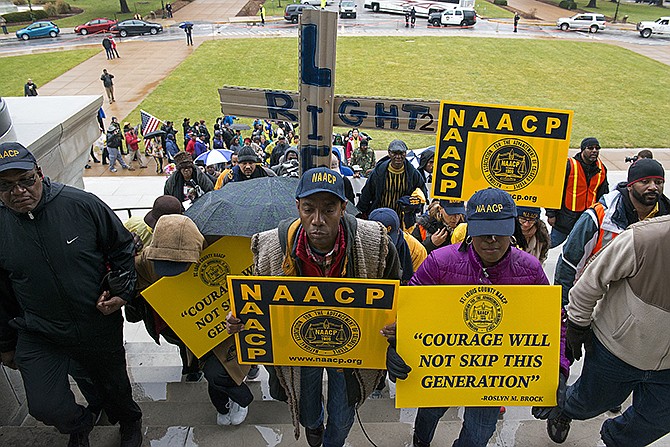 NAACP President Cornell William Brooks leads marchers up the steps of the Capitol building Friday.