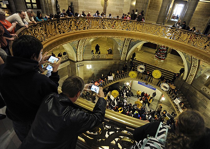 Onlookers watch and listen from the third floor overlook as Michael Brown's mother Lesley McSpadden speaks during a rally in the Missouri Capitol rotunda following the conclusion of the NAACP-led "Journey for Justice: Ferguson to Jefferson City" march on Friday. The march completed its 130-mile journey just after noon, moving through downtown Jefferson City and eventually gathering in the Capitol rotunda for the scheduled rally.