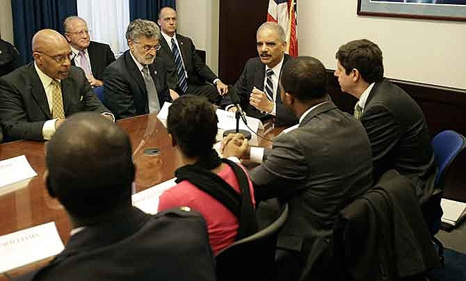 U.S. Attorney General Eric Holder holds a roundtable meeting with law enforcement, local officials, and community leaders Thursday, Dec. 4, 2014, in Cleveland. The U.S. Justice Department issued a report Thursday that says Cleveland police officers use excessive and unnecessary force far too often, are poorly trained in tactics and firearm use and place the public and their fellow officers in danger because of reckless behaviors.