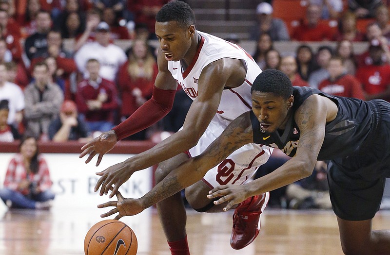 Oklahoma guard Buddy Hield and Missouri forward D'Angelo Allen reach for the ball during Friday night's game in Norman, Okla.