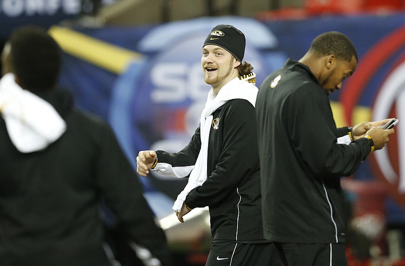 Missouri quarterback Maty Mauk (center) and some of his Tiger teammates walk on the field Friday at the Georgia Dome in Atlanta. Mauk and Missouri will face the Alabama Crimson Tide today in the Southeastern Conference title game.