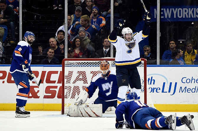 St. Louis Blues center David Backes (42) celebrates defenseman Kevin Shattenkirk's goal as New York Islanders goalie Jaroslav Halak (41), Nick Leddy (2) and right wing Cal Clutterbuck (15) react in the second period of an NHL hockey game at Nassau Coliseum on Saturday, Dec. 6, 2014, in Uniondale, N.Y.