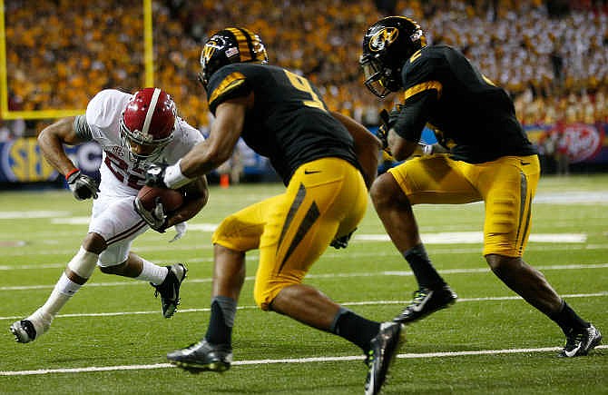 Alabama wide receiver Christion Jones (22) heads to the end zone for a touch against Missouri' Braylon Webb (9) and Duron Singleton (2) during the second half of the Southeastern Conference championship NCAA college football game, Saturday, Dec. 6, 2014, in Atlanta.