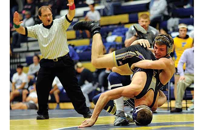 Jacob Schulte of Helias takes down Camdenton's Daniel Meier in their 152-pound match during Saturday's Kickoff Classic at Rackers Fieldhouse in Jefferson City.