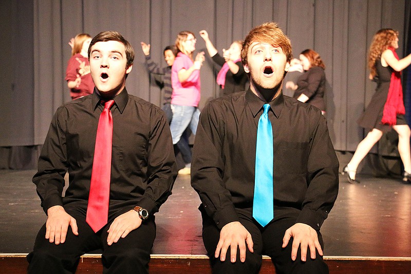 William Woods University students Trevor Gruber and Jon Meyer sing as other students dance behind them during the First Impressions Broadway musical concert rehearsal Monday night. The musical incorporated songs from Broadway musicals - some well known and some not. It played at William Woods University Monday night.