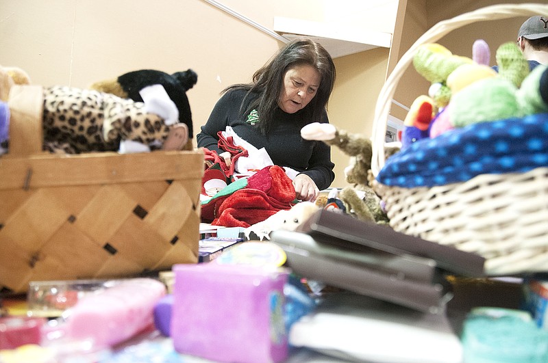 Marion Heileman of Fulton counts stocking for SERVE, Inc.'s Adopt-A-Family program on Wednesday inside Mueller Center at Westminster College. SERVE still has 355 people of the total 1,049 enrolled who need to be adopted. Their ages range from newborn to 75. The organization will continue to accept donations until Dec. 16. Gift distribution is set for Dec. 17. To contact SERVE, call (573) 642-6388.