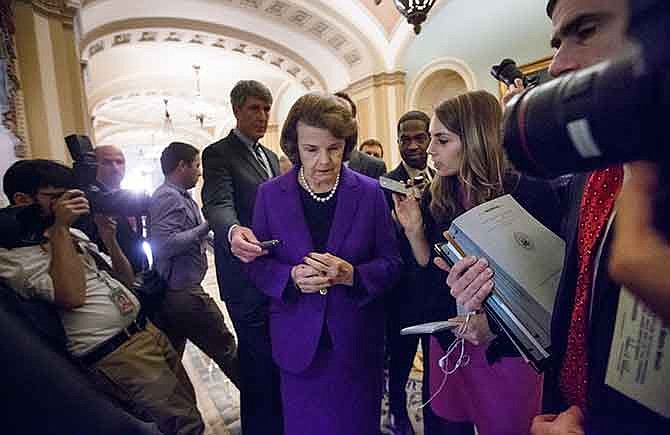 Senate Intelligence Committee Chair Sen. Dianne Feinstein, D-Calif. is surrounded by reporters on Capitol Hill in Washington, Tuesday, Dec. 9, 2014, as she leaves the Senate chamber after releasing a report on the CIA's harsh interrogation techniques at secret overseas facilities. Feinstein branded the findings a "stain on the nation's history."