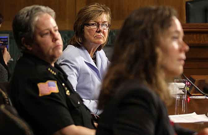 Peg Langhammer, Executive Director, Day One in Rhode Island, center, and Police Chief Kathy Zoner, left, listen as Angela Fleischer, assistant director of Student Support and Intervention for Confidential Advising at the Southern Oregon University, right, testifies on Capitol Hill in Washington, Tuesday, Dec. 9, 2014, before the Senate Crime and Terrorism subcommittee hearing: "Campus Sexual Assault: the Roles and Responsibilities of Law Enforcement."