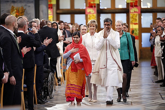 Nobel Peace Prize winners Malala Yousafzai from Pakistan, center left, and Kailash Satyarthi of India arrive for the Nobel Peace Prize award ceremony in Oslo, Norway, on Wednesday. The Nobel Peace Prize is being shared between Malala Yousafzai, the 17-year-old Taliban attack survivor, and the youngest Nobel Prize winner ever, and Indian children's rights activist Satyarthi.